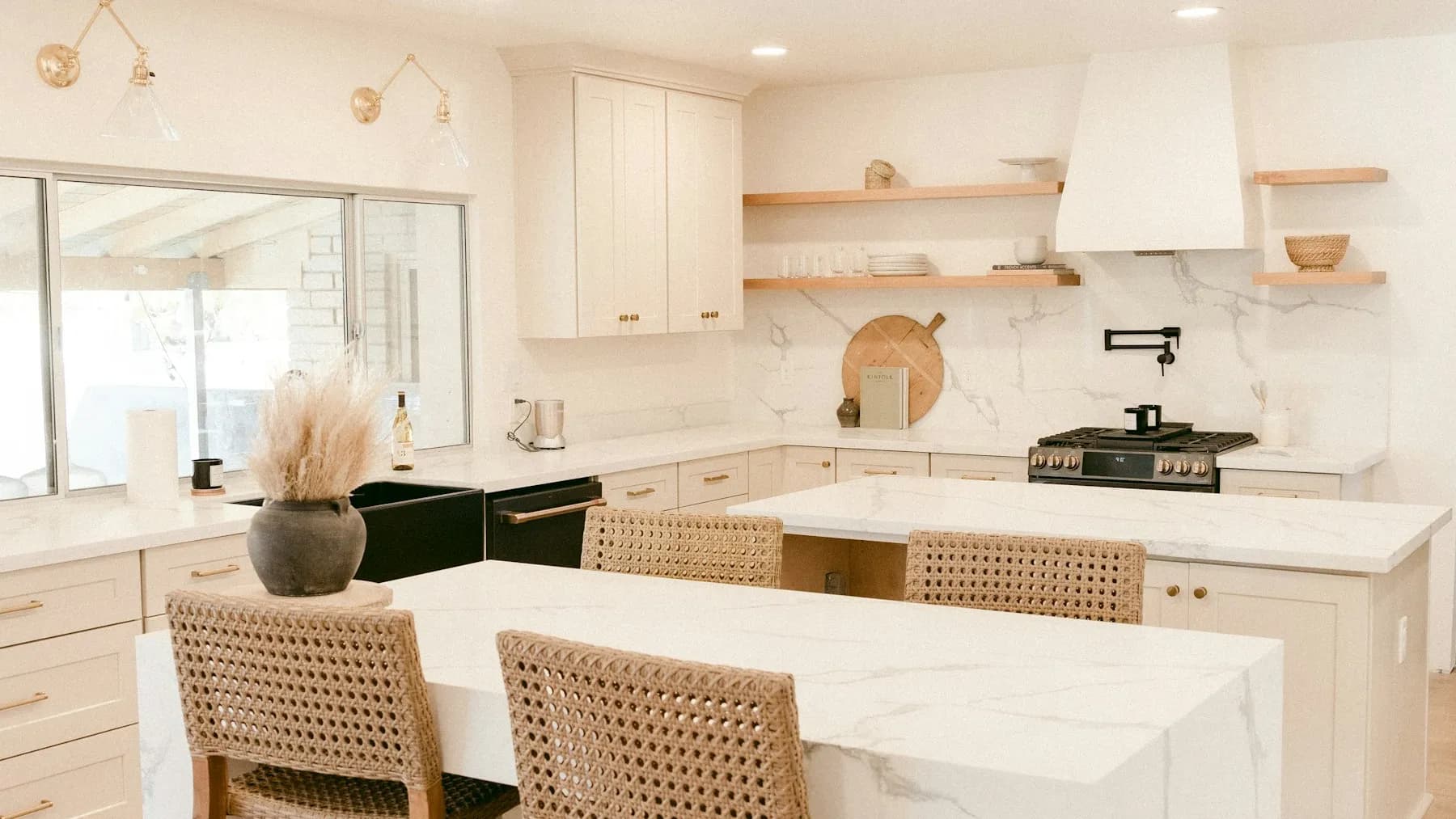 Remodelled kitchen with a large island, white cabinetry, and pendant lighting
