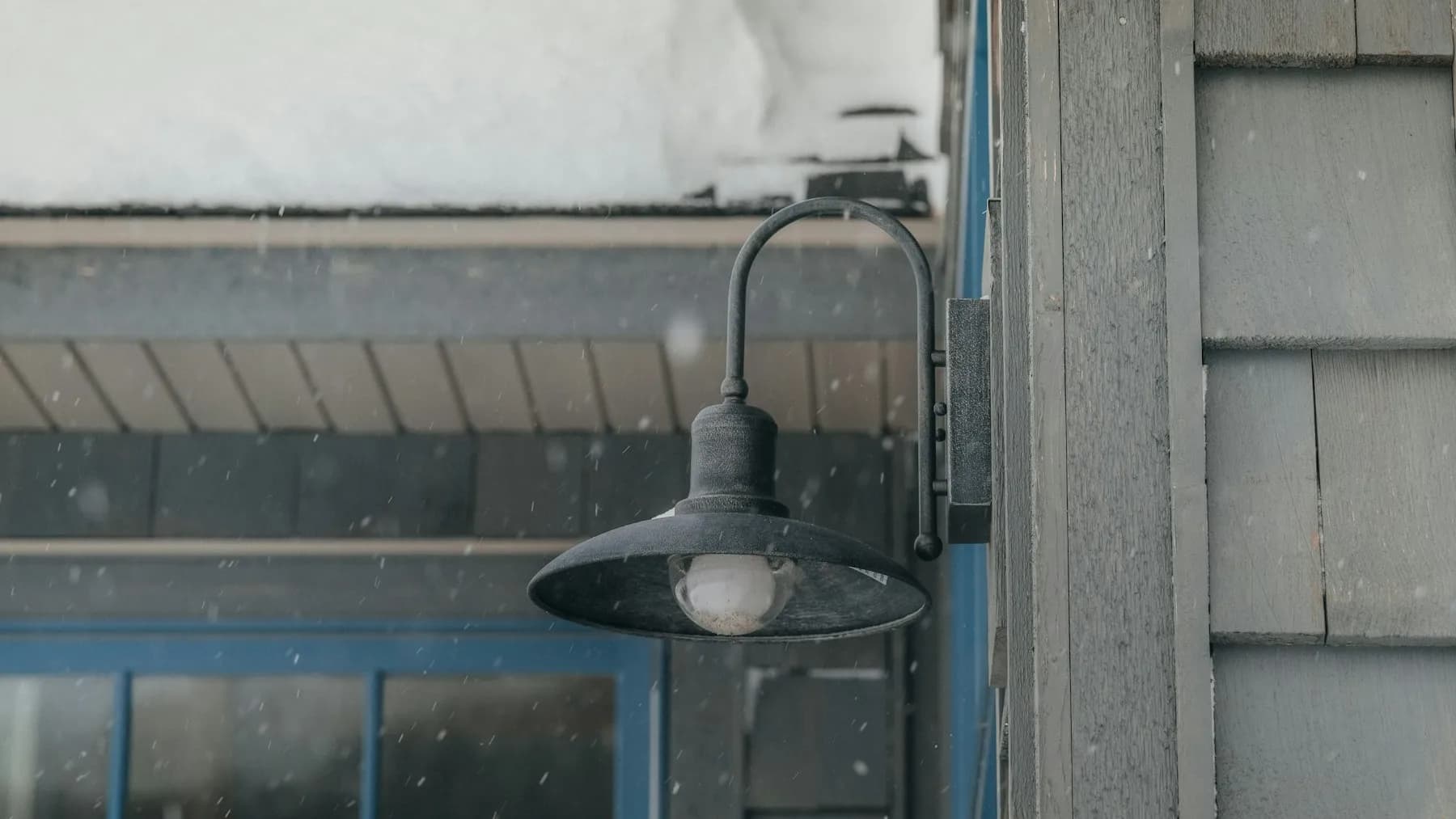 New cedar shingle siding with exterior light fixture