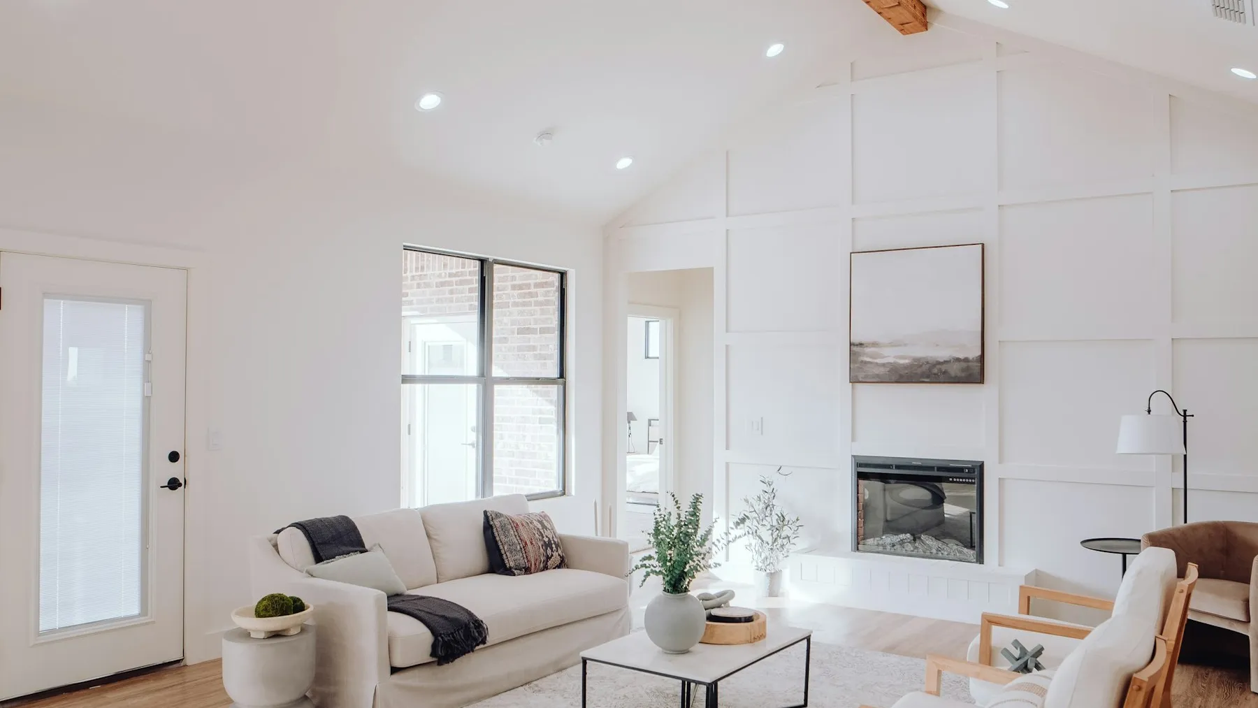 Bright restored living room with vaulted ceiling and large windows