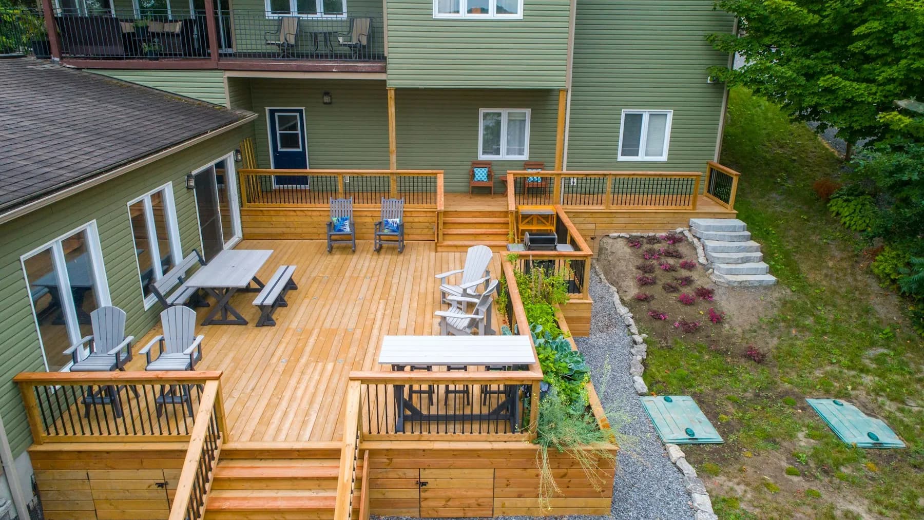 Multi-level cedar deck across the back of a house with seating areas